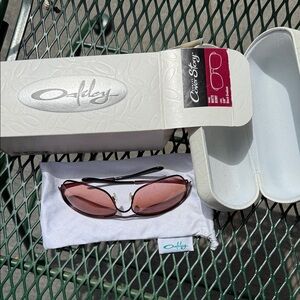 Oakley Sunglasses with Rose-Pink Lenses and Dark Frame
